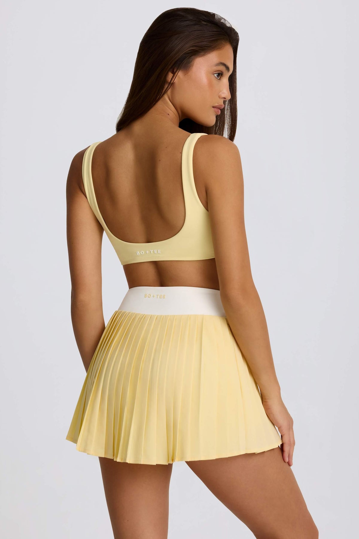 Soft Active Crossover Pleated Mini Skort In Lemon